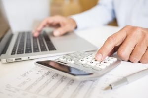 Man doing his accounting, financial adviser working personal tax accountant